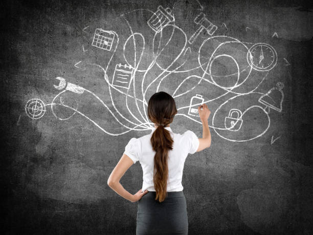 istock Businesswoman drawing on blackboard 639999170