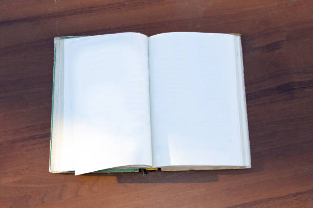 istock Open book on wooden desk 639999812