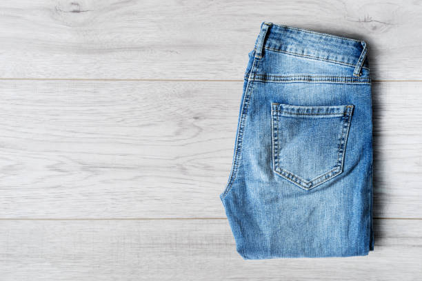 istock Jeans on wooden background 640000410