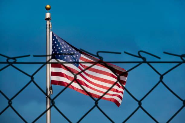 istock American flag and defocused fence 640002112