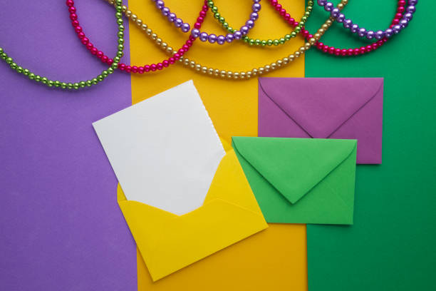istock Multi color Mardi Gras beads and envelop with card on 640005564