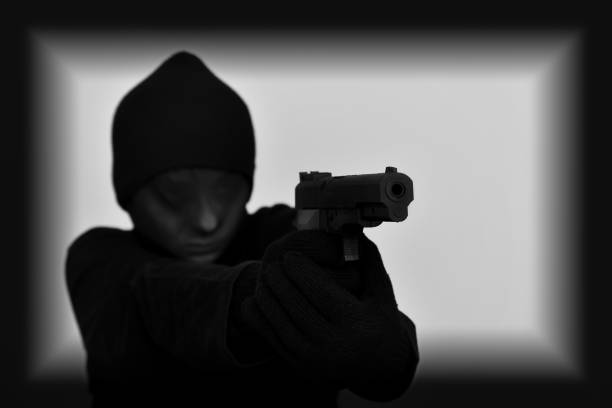 istock Female robber holding a gun 640006976