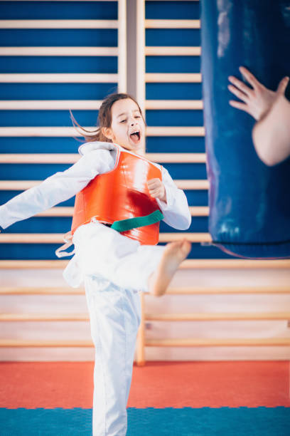istock Girl kicking punching bag 640008436