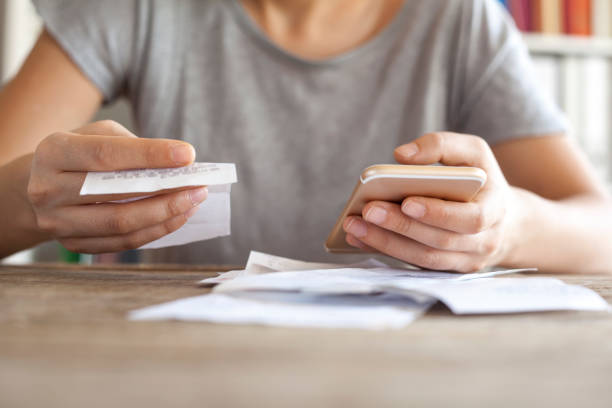 istock Woman hands with bills and mobile phone 640010036