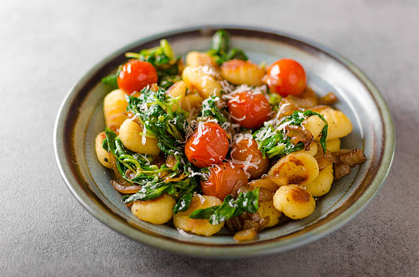 istock Gnocchi with spinach, garlic and tomatoes 640012258