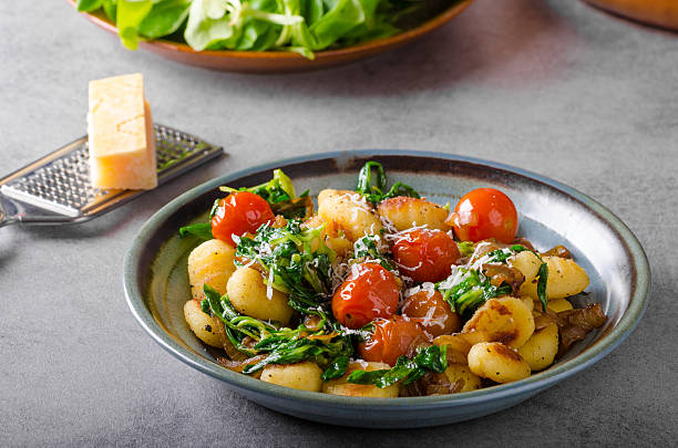 istock Gnocchi with spinach, garlic and tomatoes 640012436