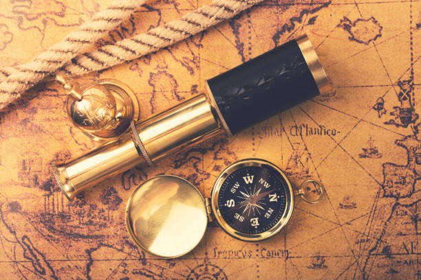 istock vintage navigation equipment on old world map. top view 640013406