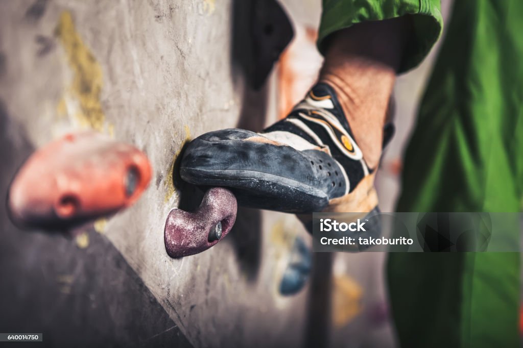 male foot on climbing wall Close-up image of male foot on climbing wall Bouldering Stock Photo