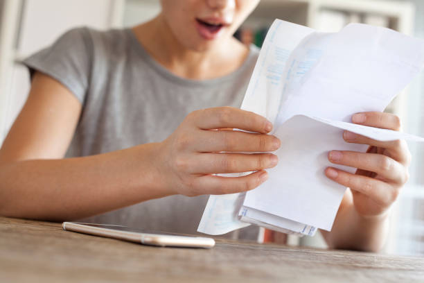 istock Amazed woman holding bills 640015684