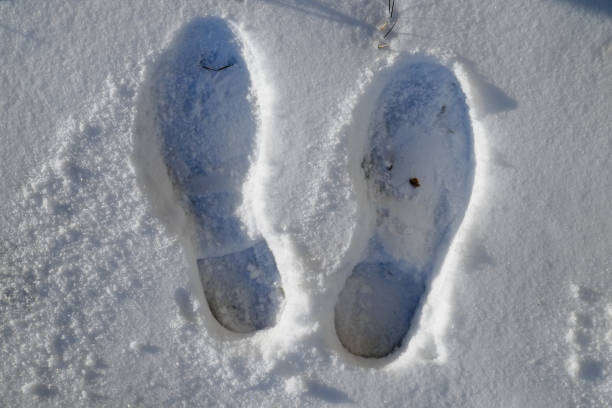istock foot steps on snow ground on fresh snowy winter day 640016852