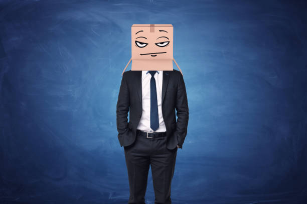 istock Businessman wearing cardboard box with drawn thoughtful face on his 640018312