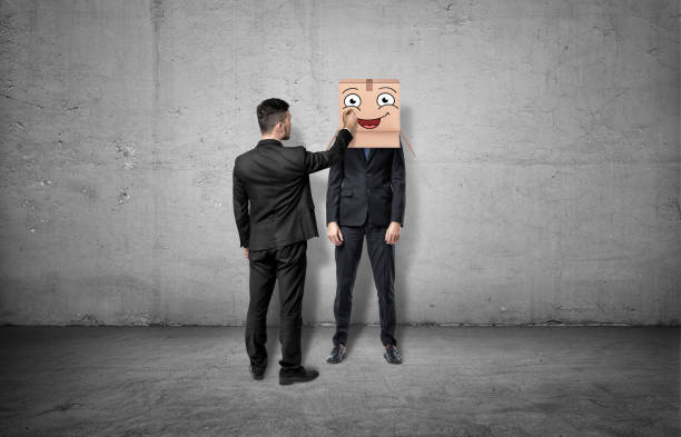 istock Businessman is drawing happy face on box which hides another 640018450
