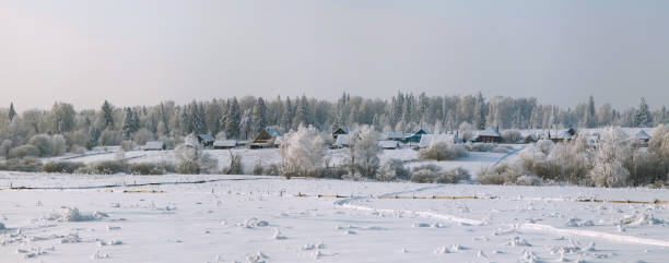 istock Winter panorama of settlement with dense forest behind 640018524