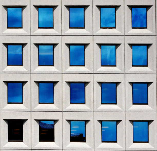 istock Clouds reflected in windows of big office building 640018758