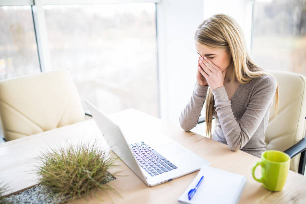 istock Tired and sad business woman at work place 640020178