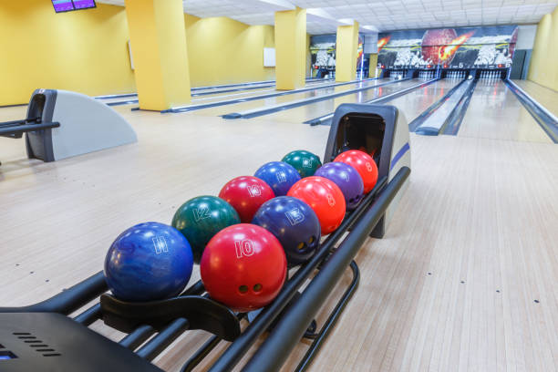 Bowling balls return machine, alley background Bowling background. Interior of bowling alley lane with balls return machine closeup bowling alley wood stock pictures, royalty-free photos & images