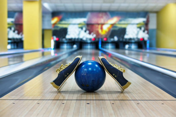 istock Bowling ball and shoes on lane background 640026694
