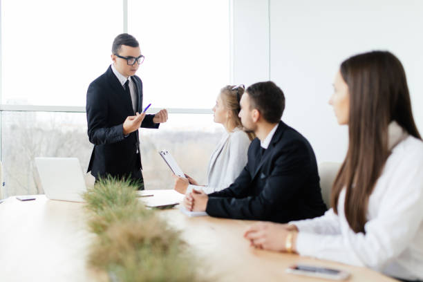 istock Business meeting. Boss in formalwear  explain and discussing something 640028604
