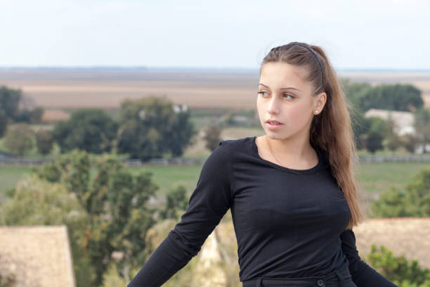 Portrait of a girl looking with hope in the sky.