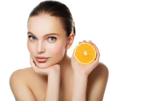 Woman holding halved orange