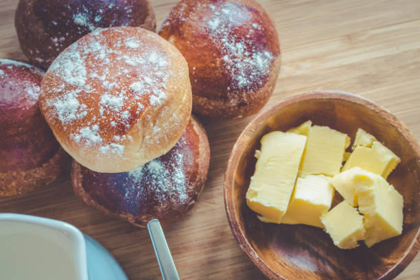 istock Breakfast with bread buns butter and milk on wooden board 640035250