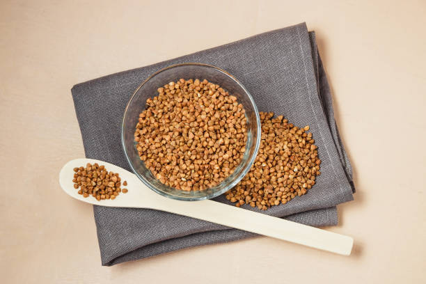 istock Buckwheat groats in bowl and wooden spoon 640038964