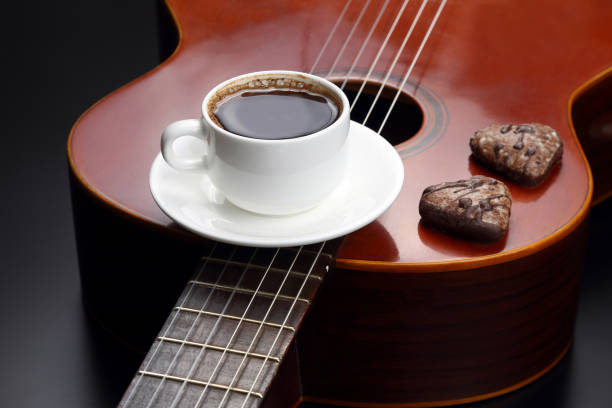 istock cup with coffee and cookies lying on the acoustic guitar 640039030