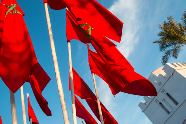 istock Moroccan flags in Marrakech on a background of blue sky 640039738