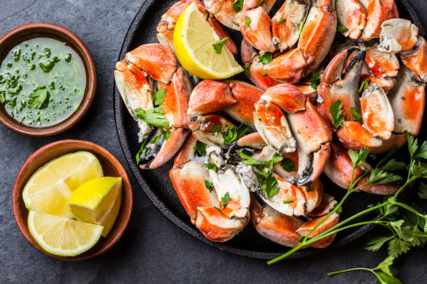 istock Crabs tentacles with wite wine, lemon, herbs sauce, slate background 640039742