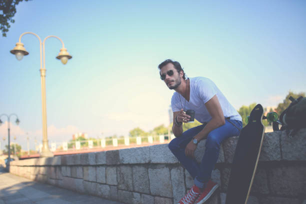 istock Hipster drinking coffee in the street 640040444