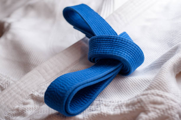 istock Blue martial arts belt with white kimono in background 640041864