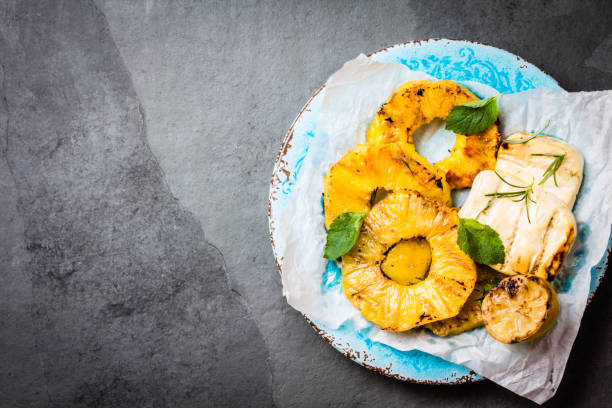 istock Grilled pineapple and cheese with fresh mint, blue plate. 640042292