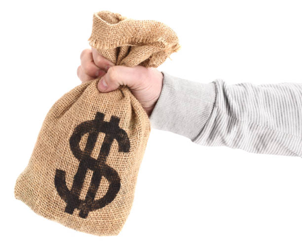 istock Man's hand is holding sack with dollar money bag 640042530