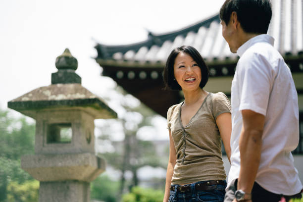 istock Cheerful japanese couple at the temple, front view 640042790