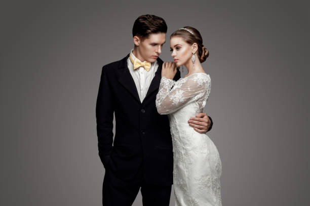 istock Groom in yellow bow-tie with bride, studio 640042918