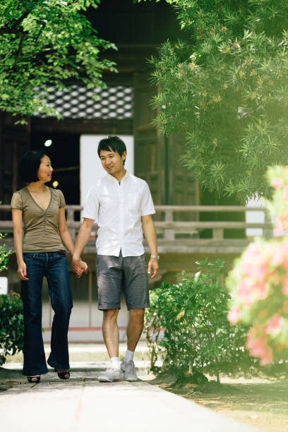 istock Cheerful japanese couple at the temple, front view 640042932