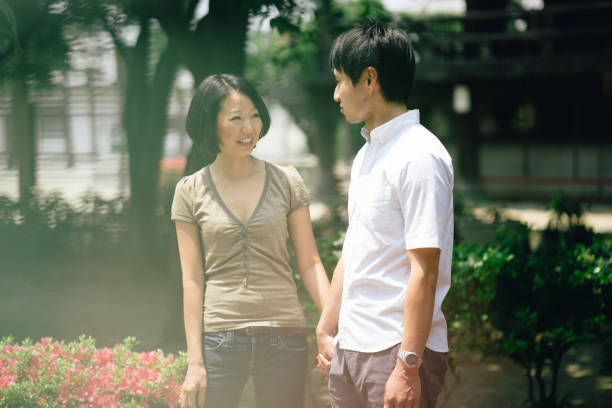 istock Cheerful japanese couple at the temple, front view 640043146
