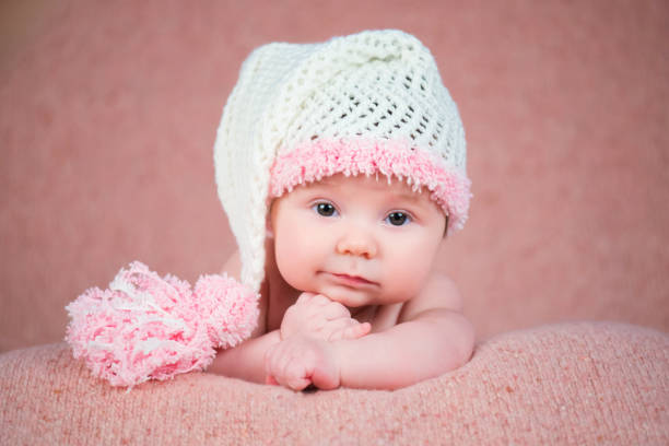 istock Newborn baby in a warm knitted hat. 640043396