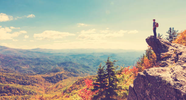 istock Man walking on the edge of a cliff 640047026