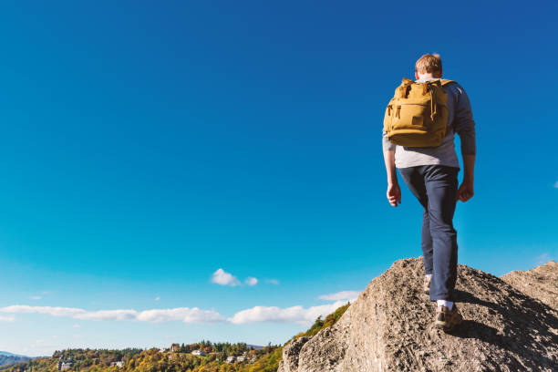 istock Man walking on the edge of a cliff 640047214
