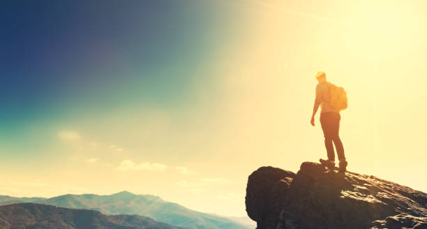 istock Man walking on the edge of a cliff 640047256