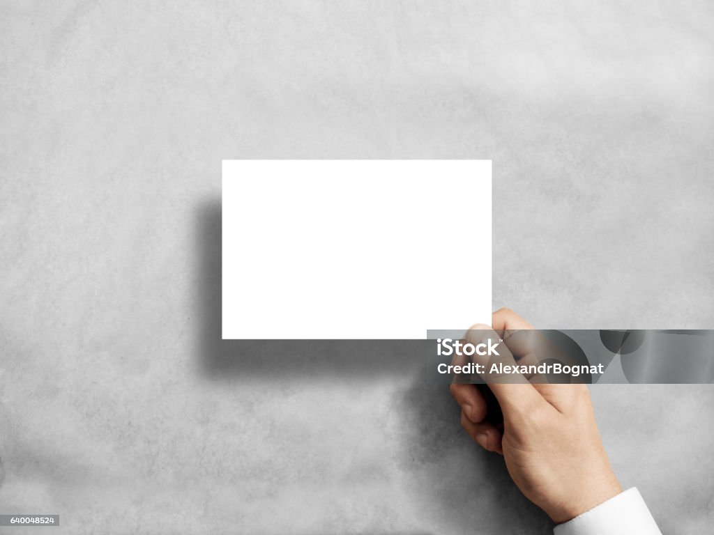 Hand holding blank white postcard flyer in the . Hand holding blank white postcard flyer mockup. 6 x 4 leaflet mock up presentation. Postal holder. Man show clear post card paper. Sheet template. Invitation booklet reading first person view Postcard Stock Photo