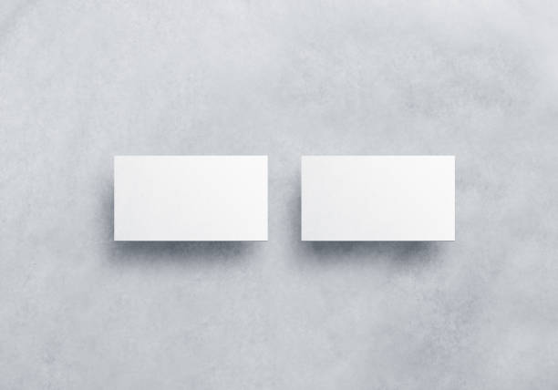 Blank white business card mockups isolated on grey textured background