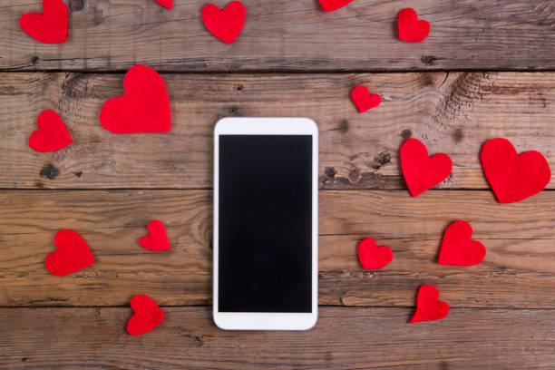 istock smartphone with red heart on wood table 640050354