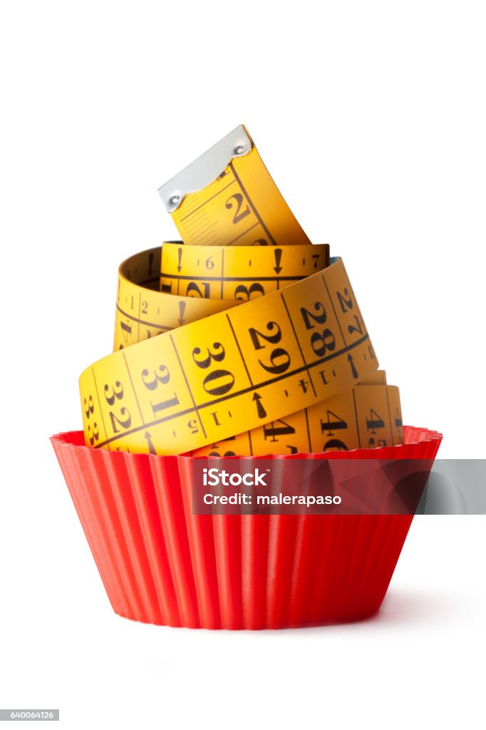 Cupcake diet Cupcake wrapper and a measuring tape for a diet. Concepts Stock Photo