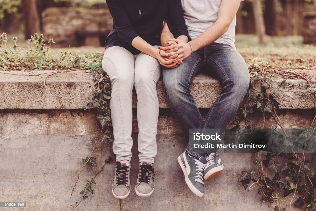 Loving couple holding hands Cropped photo of young couple holding hands Teenager Stock Photo