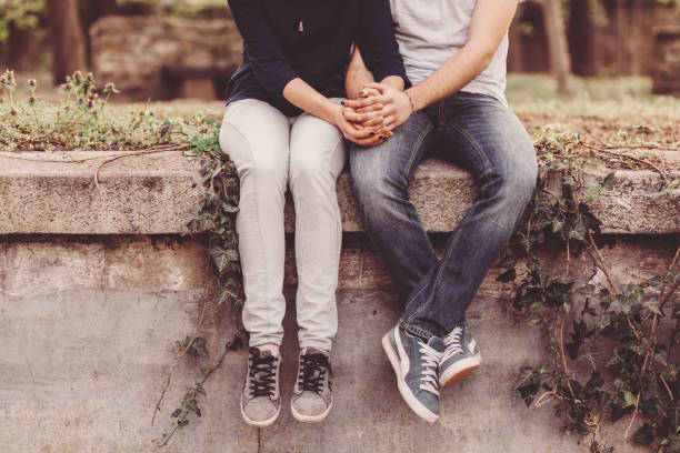 Loving couple holding hands Cropped photo of young couple holding hands couple holding hands stock pictures, royalty-free photos & images