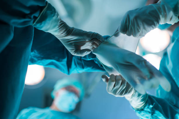 istock Assistance in putting surgical gloves! 640066664