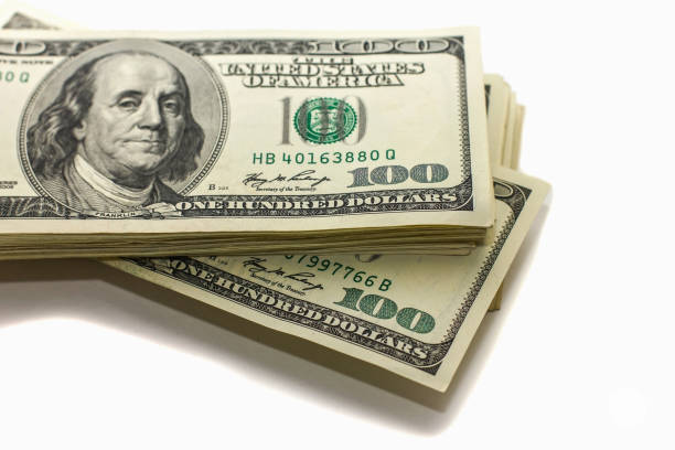 istock hundred-dollar bills in a pile on a white background, 640066868
