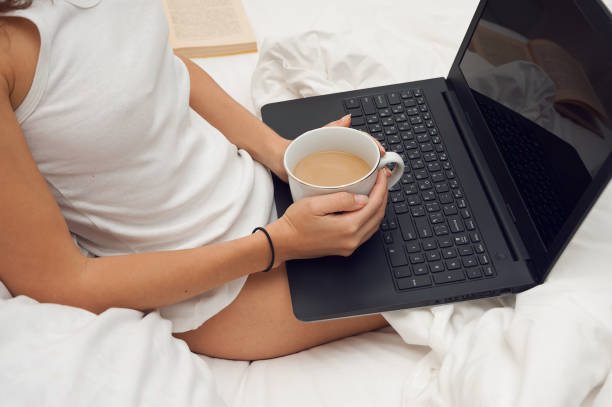 istock Womanwith laptop in a bed 640067304